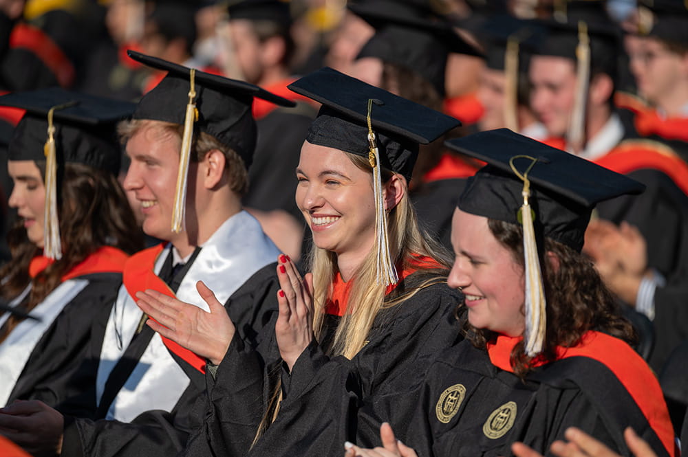 Georgia Tech graduate students clapping at commencement