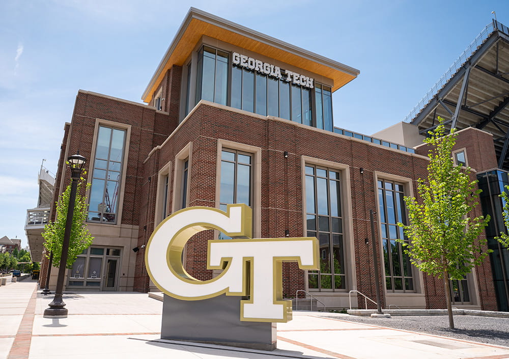 GT logo sign in front of Georgia Tech campus building